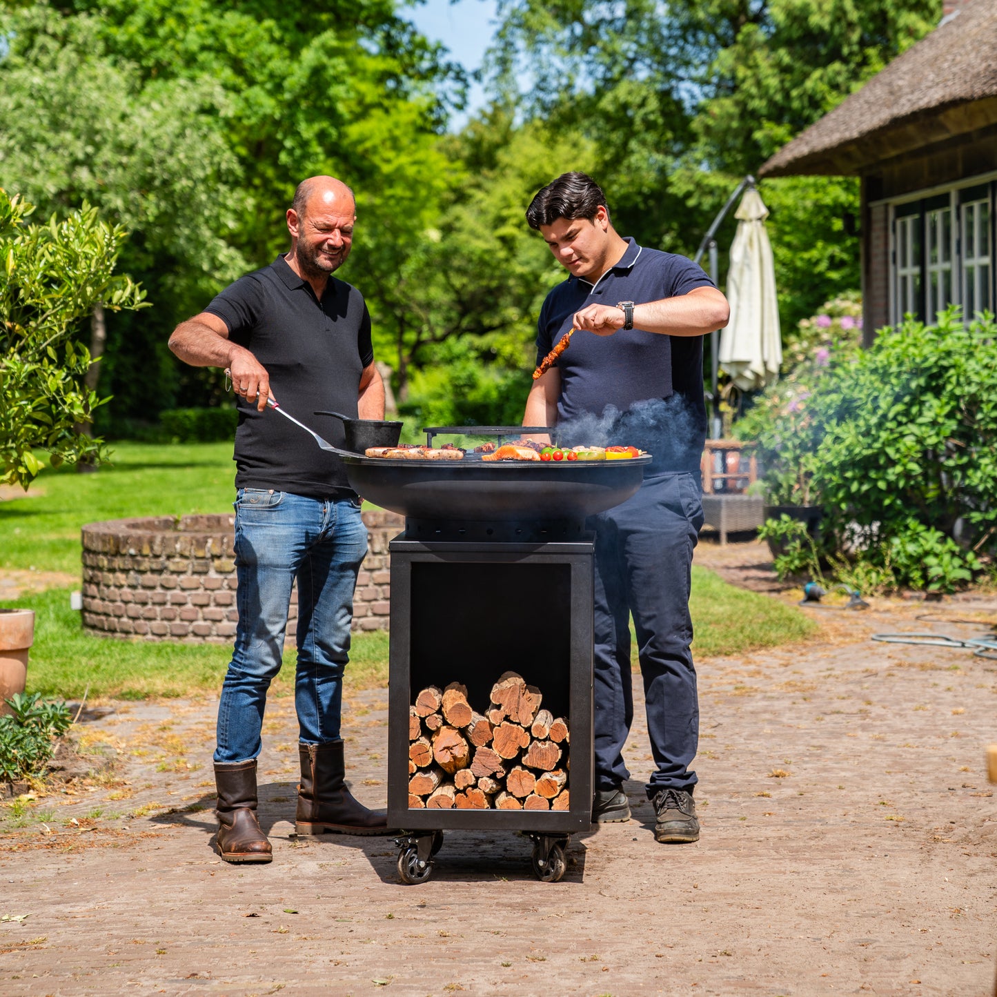 BBQ Plancha Grill Hermano XXL Blackline - With poker and wood storage Ø80cm 8mm